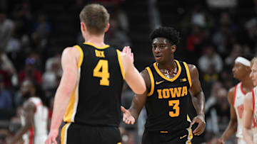 Mar 12, 2025; Indianapolis, IN, USA; Iowa Hawkeyes guard Josh Dix (4) and Iowa Hawkeyes guard Drew Thelwell (3) celebrate after a play during the first half against the Ohio State Buckeyes at Gainbridge Fieldhouse. Mandatory Credit: Robert Goddin-Imagn Images