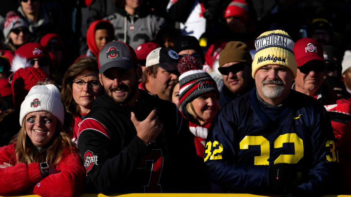 Nov. 25, 2023; Ann Arbor, Mi., USA;
A Michigan fan stands among a scarlet sea of Ohio State fans waiting for the team to arrive outside of Michigan Stadium before Saturday  s NCAA Division I football game against the Ohio State Buckeyes and the Michigan Wolverines at Michigan Stadium.