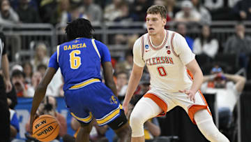 Mar 20, 2025; Providence, RI, USA; McNeese State Cowboys guard Javohn Garcia (6) brings the ball downcourt against Clemson Tigers center Viktor Lakhin (0) during the first half at Amica Mutual Pavilion. Mandatory Credit: Eric Canha-Imagn Images