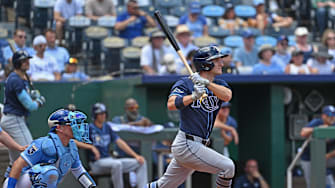 Tampa Bay Rays left fielder Jake Mangum (28) hits a RBI triple in the fourth inning against the Kansas City Royals at Kauffman Stadium. 
