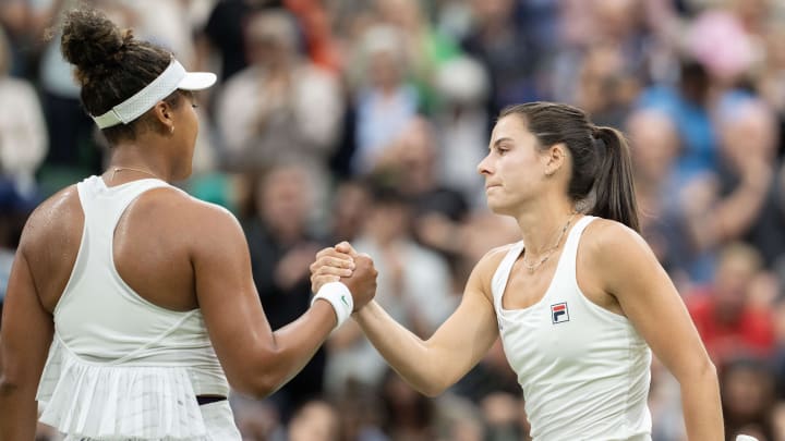 Emma Navarro shakes hands with Naomi Osaka after their second round match at Wimbledon Centre Court.