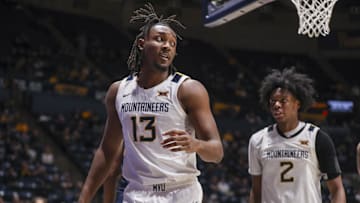 Dec 3, 2025; Morgantown, West Virginia, USA; West Virginia Mountaineers guard Chance Moore (13) celebrates after a play during the second half against the Coppin State Eagles at Hope Coliseum. Mandatory Credit: Ben Queen-Imagn Images