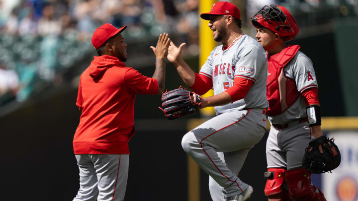 Jul 24, 2024; Seattle, Washington, USA;  Los Angeles Angels designated hitter Willie Calhoun (5), left, relief pitcher Carlos Estevez (53), center, and catcher Matt Thaiss (21) celebrate after a game Mariners at T-Mobile Park. Mandatory Credit: Stephen Brashear-USA TODAY Sports