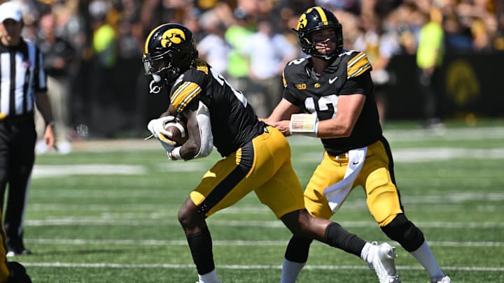 Aug 31, 2024; Iowa City, Iowa, USA; Iowa Hawkeyes running back Kaleb Johnson (2) takes the handoff from quarterback Cade McNamara (not pictured) against the Illinois State Redbirds during the fourth quarter at Kinnick Stadium. Mandatory Credit: Jeffrey Becker-Imagn Images