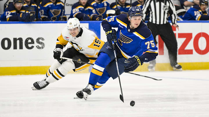 Apr 3, 2025; St. Louis, Missouri, USA;  St. Louis Blues defenseman Tyler Tucker (75) controls the puck against the Pittsburgh Penguins during the first period at Enterprise Center. Mandatory Credit: Jeff Curry-Imagn Images