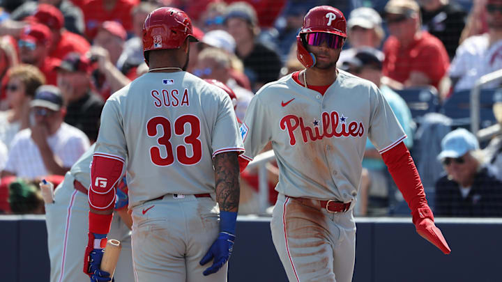Feb 25, 2025; Port Charlotte, Florida, USA;  Philadelphia Phillies outfielder Justin Crawford (80) celebrates with shortstop Edmundo Sosa (33) after scoring a run against the Tampa Bay Rays at Charlotte Sports Park. Mandatory Credit: Kim Klement Neitzel-Imagn Images