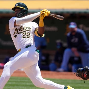 Jun 9, 2024; Oakland, California, USA; Oakland Athletics left fielder Miguel Andujar (22) hits a double against the Toronto Blue Jays during the fourth inning at Oakland-Alameda County Coliseum. 