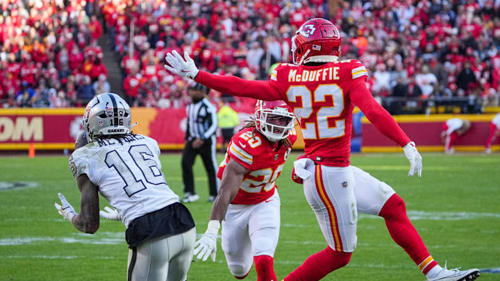 Nov 29, 2024; Kansas City, Missouri, USA; Las Vegas Raiders wide receiver Jakobi Meyers (16) catches a pass as Kansas City Chiefs cornerback Trent McDuffie (22) defends during the first half at GEHA Field at Arrowhead Stadium. Mandatory Credit: Denny Medley-Imagn Images