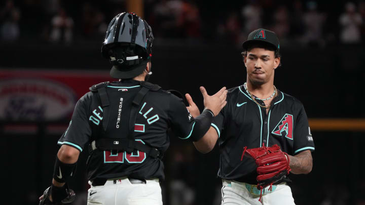 Aug 12, 2024; Phoenix, Arizona, USA; Arizona Diamondbacks catcher Adrian Del Castillo (25) and pitcher Justin Martinez (63) celebrate after defeating the Colorado Rockies at Chase Field. Mandatory Credit: Rick Scuteri-USA TODAY Sports