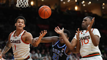 Feb 25, 2025; Coral Gables, Florida, USA;  Miami (Fl) Hurricanes center Lynn Kidd (1), Duke Blue Devils center Patrick Ngongba II (21) and guard Paul Djobet (10) battle for a rebound during the first half at Watsco Center. Mandatory Credit: Jim Rassol-Imagn Images