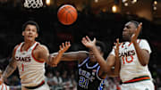 Feb 25, 2025; Coral Gables, Florida, USA;  Miami (Fl) Hurricanes center Lynn Kidd (1), Duke Blue Devils center Patrick Ngongba II (21) and guard Paul Djobet (10) battle for a rebound during the first half at Watsco Center. Mandatory Credit: Jim Rassol-Imagn Images