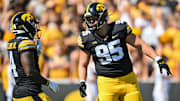 Sep 2, 2023; Iowa City, Iowa, USA; Iowa Hawkeyes defensive lineman Aaron Graves (95) and running back Leshon Williams (4) in action during the game against the Utah State Aggies at Kinnick Stadium. Mandatory Credit: Jeffrey Becker-Imagn Images