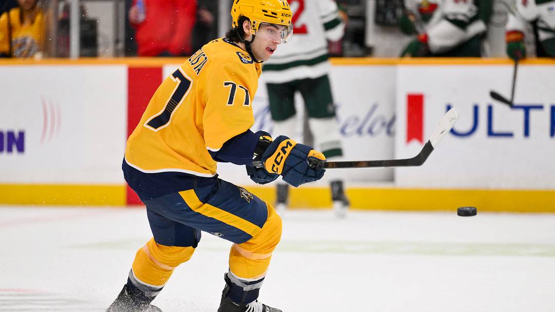 Feb 4, 2026; Nashville, Tennessee, USA;  Nashville Predators right wing Luke Evangelista (77) knocks the puck down against the Minnesota Wild during the third period at Bridgestone Arena. Mandatory Credit: Steve Roberts-Imagn Images