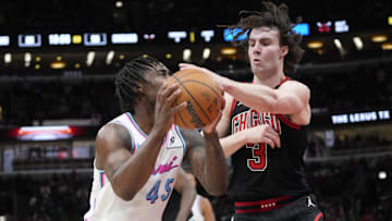 Apr 9, 2025; Chicago, Illinois, USA; Chicago Bulls guard Josh Giddey (3) defends Miami Heat guard Davion Mitchell (45) during the second half at United Center. Mandatory Credit: David Banks-Imagn Images