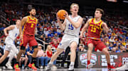 Mar 13, 2025; Kansas City, MO, USA; Brigham Young Cougars forward Richie Saunders (15) drives to the basket around Iowa State Cyclones guard Cade Kelderman (13) during the first half at T-Mobile Center. Mandatory Credit: William Purnell-Imagn Images