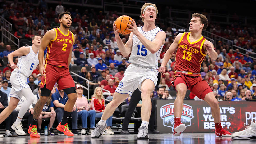 Mar 13, 2025; Kansas City, MO, USA; Brigham Young Cougars forward Richie Saunders (15) drives to the basket around Iowa State Cyclones guard Cade Kelderman (13) during the first half at T-Mobile Center. Mandatory Credit: William Purnell-Imagn Images