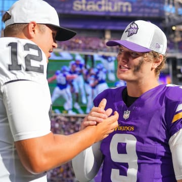 Minnesota Vikings quarterback J.J. McCarthy (9) and Las Vegas Raiders quarterback Aidan O'Connell (12) talk 