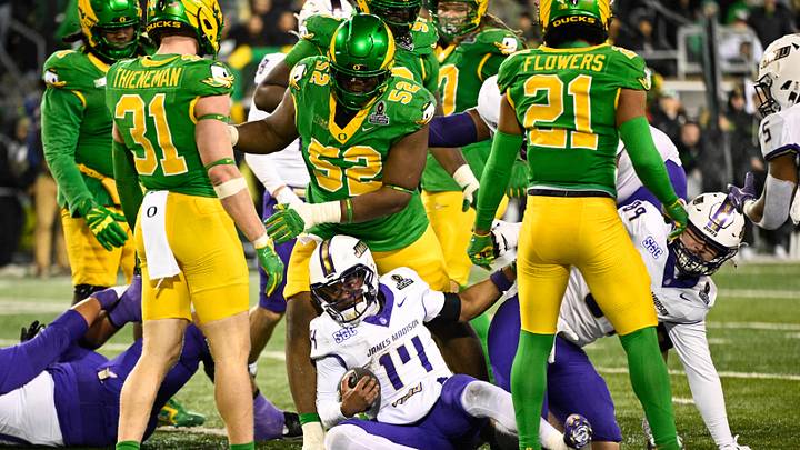 Dec 20, 2025; Eugene, OR, USA;  James Madison Dukes quarterback Alonza Barnett III (14) scores a touchdown during the fourth quarter against the Oregon Ducks at Autzen Stadium. Mandatory Credit: Troy Wayrynen-Imagn Images