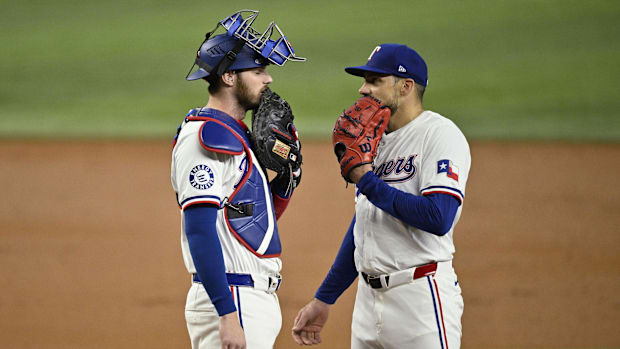 Nathan Eovaldi, right, with catcher Jonah Heim, will start the season finale for the Texas Rangers Sunday.