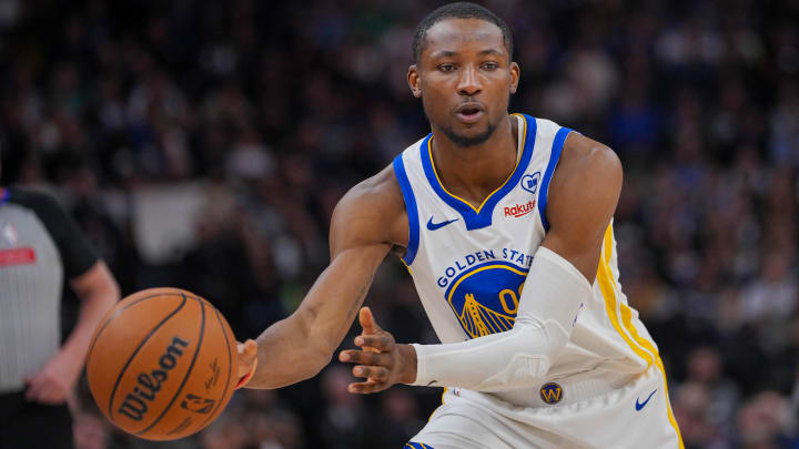 Mar 24, 2024; Minneapolis, Minnesota, USA; Golden State Warriors forward Jonathan Kuminga (00) passes against the Minnesota Timberwolves in the fourth quarter at Target Center. Mandatory Credit: Brad Rempel-USA TODAY Sports