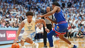 Nov 7, 2025; Chapel Hill, North Carolina, USA;  North Carolina Tar Heels guard Seth Trimble (7) with the ball as Kansas Jayhawks guard Elmarko Jackson (13) defends in the second half at Dean E. Smith Center. Mandatory Credit: Bob Donnan-Imagn Images
