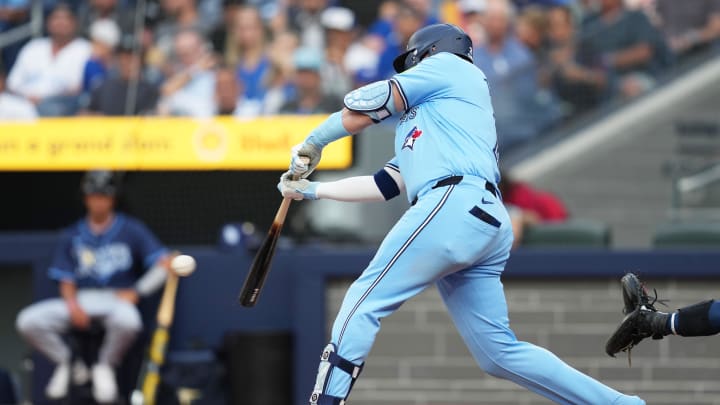 Jul 23, 2024; Toronto, Ontario, CAN; Toronto Blue Jays designated hitter Justin Turner (2) hits a single against the Tampa Bay Rays during the first inning at Rogers Centre.