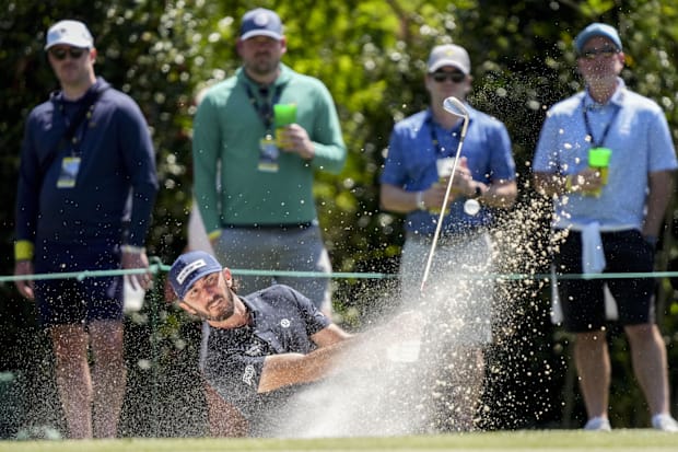 Max Homa hits out of a bunker on the fourth hole.
