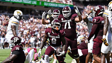 Oct 5, 2024; College Station, Texas, USA; Texas A&M Aggies running back Le'Veon Moss (8) reacts after scoring a touchdown in the first half against the Missouri Tigers at Kyle Field. Mandatory Credit: Maria Lysaker-Imagn Images. 