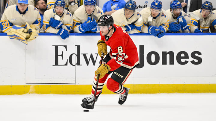 Feb 8, 2025; St. Louis, Missouri, USA;  Chicago Blackhawks center Ryan Donato (8) controls the puck against the St. Louis Blues during shootouts at Enterprise Center. Mandatory Credit: Jeff Curry-Imagn Images