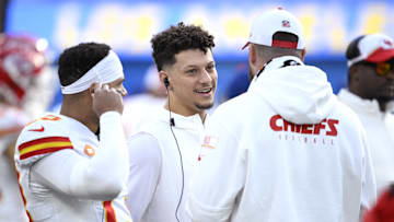 Jan 7, 2024; Inglewood, California, USA; Kansas City Chiefs quarterback Patrick Mahomes (center) speaks with quarterback Chris Oladokun (13) and tight end Travis Kelce (right) during the first half against the Los Angeles Chargers at SoFi Stadium. Mandatory Credit: Orlando Ramirez-Imagn Images