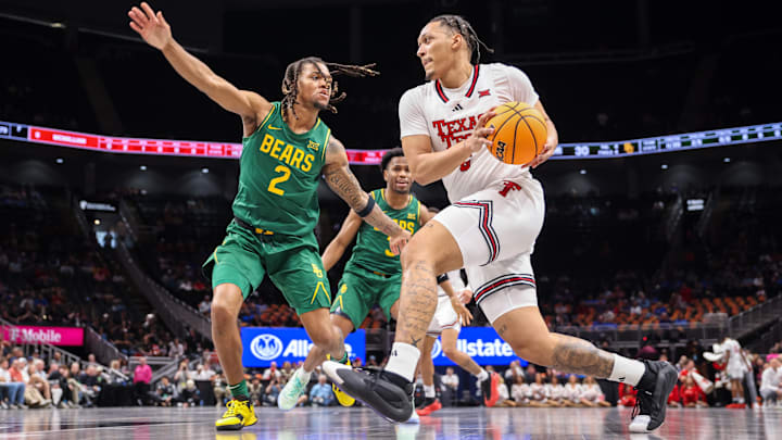 Mar 13, 2025; Kansas City, MO, USA; Texas Tech Red Raiders forward Darrion Williams (5) drives to the basket around Baylor Bears guard Jayden Nunn (2) during the first half at T-Mobile Center. Mandatory Credit: William Purnell-Imagn Images