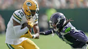 Green Bay Packers wide receiver Malik Heath (18) makes a catch before being tackles by Seattle Seahawks cornerback Shaquill Griffin (24) during the first quarter of their preseason game Saturday, August 23, 2025 at Lambeau Field in Green Bay, Wisconsin.