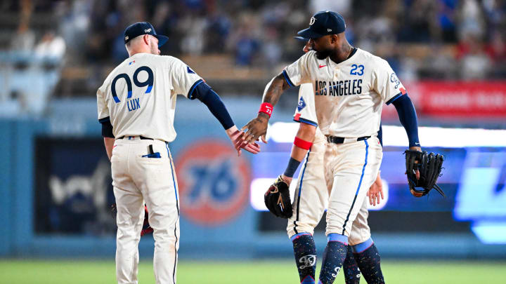 Jun 22, 2024; Los Angeles, California, USA; Los Angeles Dodgers outfielder Jason Heyward (23) and second baseman Gavin Lux (9) celebrate after defeating the Los Angeles Angels during the ninth inning at Dodger Stadium. Mandatory Credit: Jonathan Hui-USA TODAY Sports