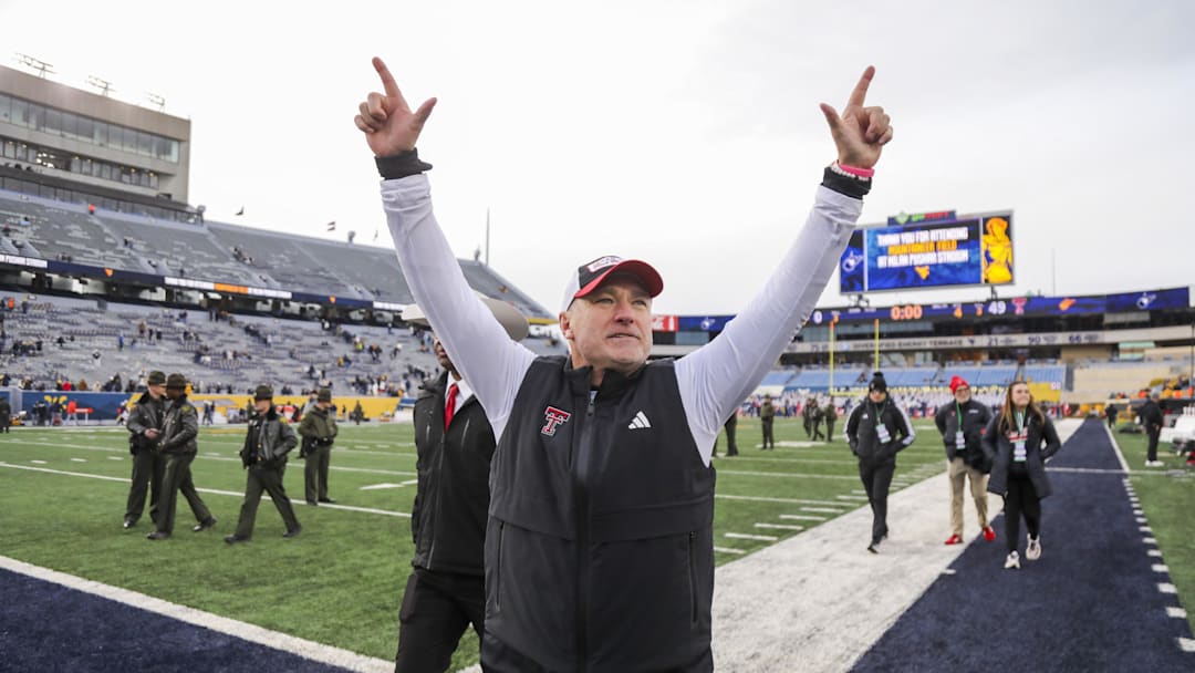 Nov 29, 2025; Morgantown, West Virginia, USA; Texas Tech Red Raiders head coach Joey McGuire celebrates with fans after defeating the West Virginia Mountaineers at Milan Puskar Stadium. Mandatory Credit: Ben Queen-Imagn Images