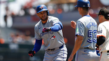 Jul 11, 2024; San Francisco, California, USA; Toronto Blue Jays outfielder George Springer (4) celebrates with first base coach Mark Budzinski (53) after hitting a single during the first inning against the San Francisco Giants at Oracle Park. Mandatory Credit: Sergio Estrada-Imagn Images