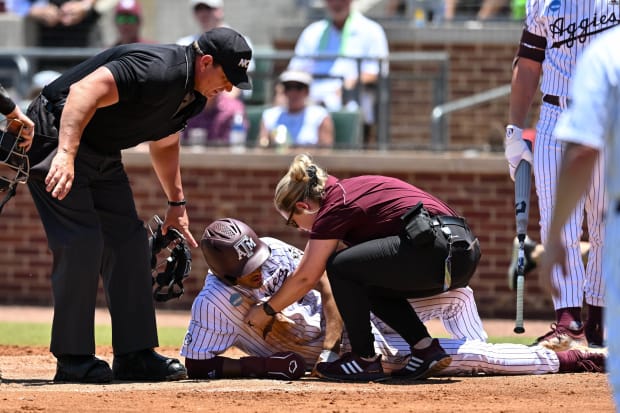 Texas A&M outfielder Braden Montgomery (6) is looked at by the medical staff and home plate umpire Mark Wagers after sliding.