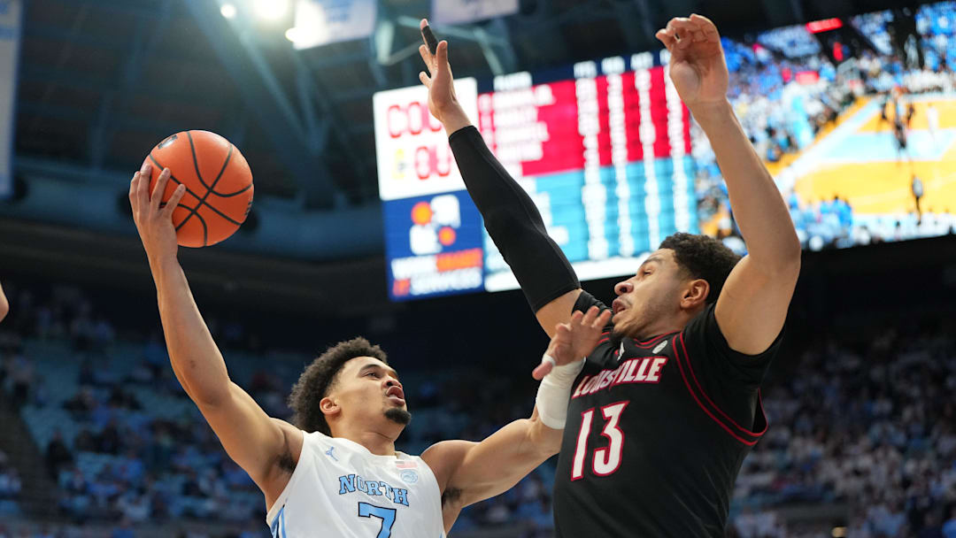 Feb 23, 2026; Chapel Hill, North Carolina, USA; North Carolina Tar Heels guard Seth Trimble (7) shoots as Louisville Cardinals forward Sananda Fru (13) defends in the second half at Dean E. Smith Center. Mandatory Credit: Bob Donnan-Imagn Images Feb 23, 2026; Chapel Hill, North Carolina, USA; North Carolina Tar Heels guard Seth Trimble (7) shoots as Louisville Cardinals forward Sananda Fru (13) defends in the second half at Dean E. Smith Center. Mandatory Credit: Bob Donnan-Imagn Images