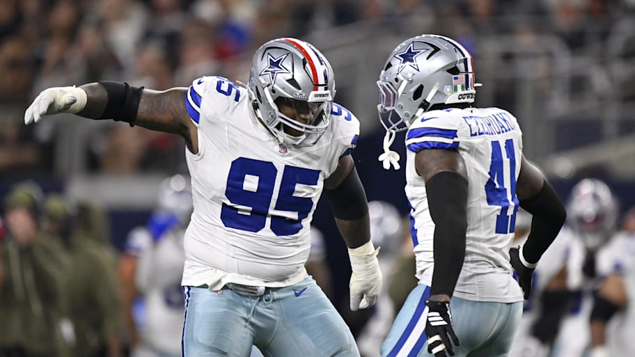Dallas Cowboys defensive tackle Kenny Clark celebrates with defensive end Donovan Ezeiruaku
