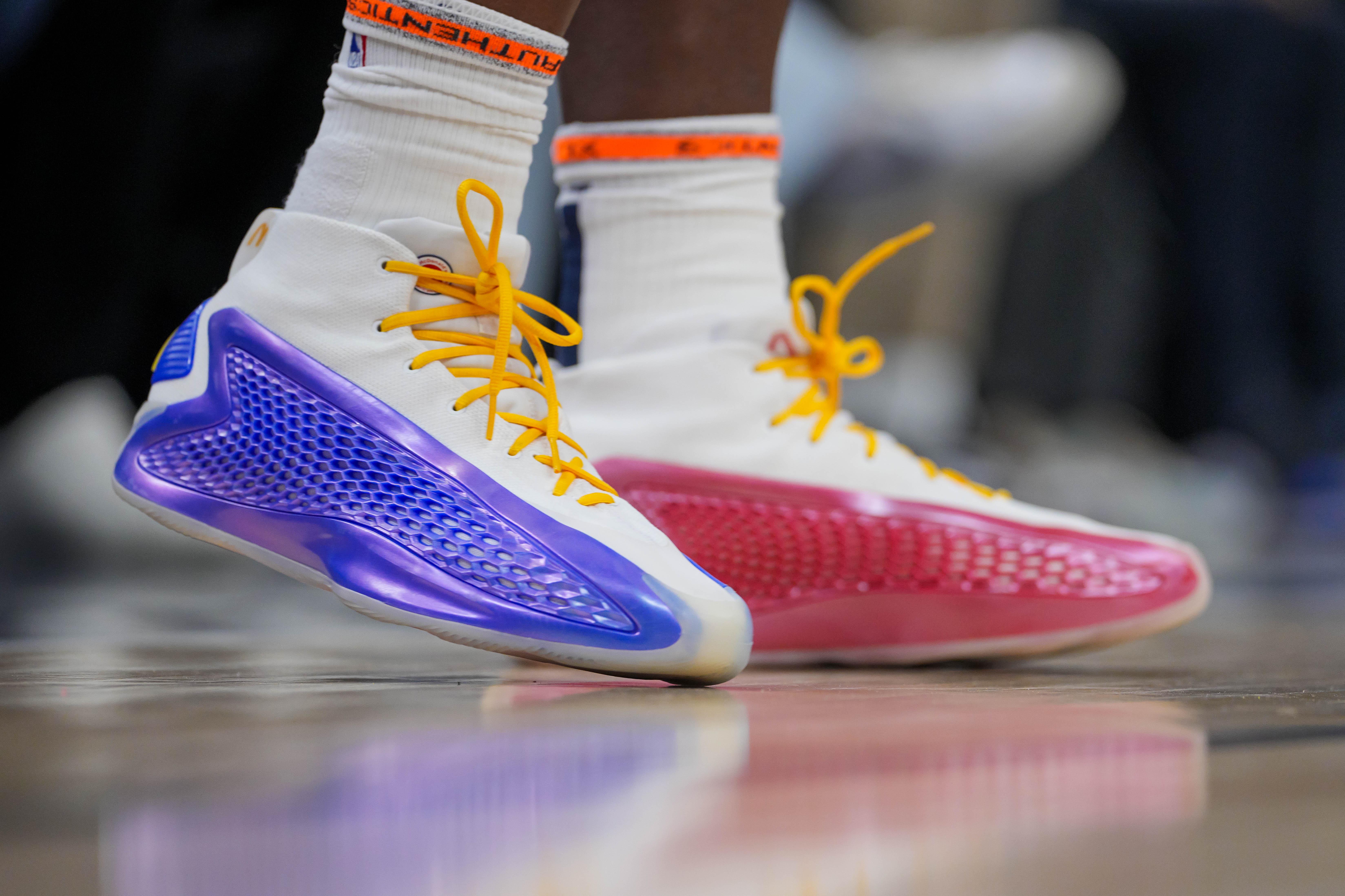 Minnesota Timberwolves guard Anthony Edwards' red and blue adidas sneakers.