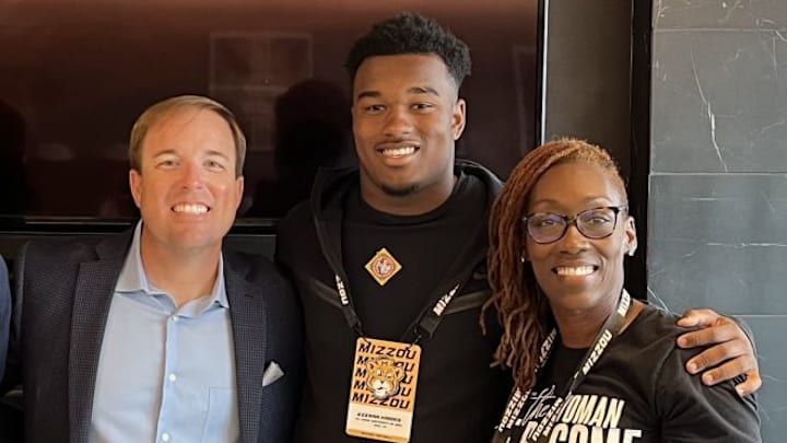 Harris family with coach Eliah Drinkwitz 