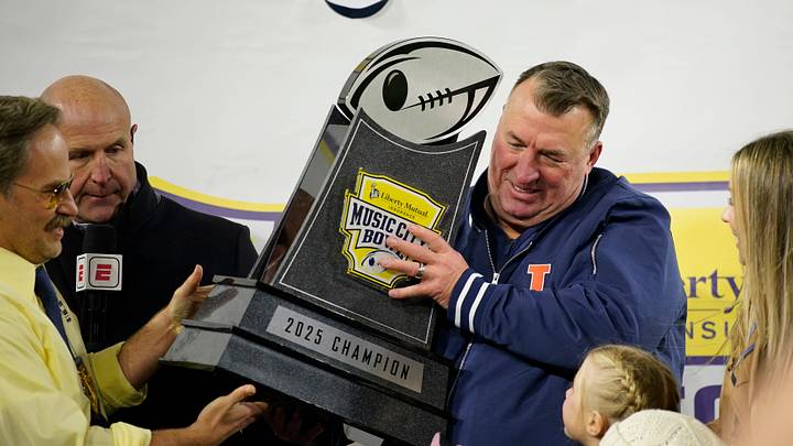 Illinois coach Bret Bielema is presented with the Music City Bowl trophy after defeating Tennessee in an NCAA college football game on Dec. 30, 2025, in Nashville, Tennessee.