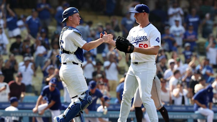 Sep 8, 2024; Los Angeles, California, USA;  Los Angeles Dodgers relief pitcher Evan Phillips (59) celebrates a victory with catcher Will Smith (16) after defeating the Cleveland Guardians 4-0 at Dodger Stadium. Mandatory Credit: Kiyoshi Mio-Imagn Images