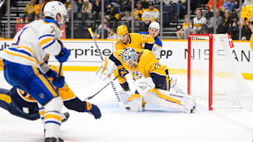 Feb 8, 2025; Nashville, Tennessee, USA;  Nashville Predators goalie Justus Annunen (29) blocks a shot by Buffalo Sabres center Ryan McLeod (71) during the second period at Bridgestone Arena. Mandatory Credit: Steve Roberts-Imagn Images