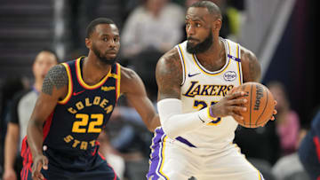 Los Angeles Lakers forward LeBron James (right) handles the ball against Golden State Warriors forward Andrew Wiggins (22) during the third quarter at Chase Center.
