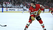 Mar 7, 2025; Chicago, Illinois, USA;  Chicago Blackhawks center Connor Bedard (98) moves the puck against the Utah Hockey Club during the first period at the United Center. Mandatory Credit: Matt Marton-Imagn Images
