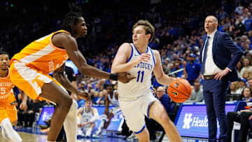 Feb 11, 2025; Lexington, Kentucky, USA; Kentucky Wildcats guard Travis Perry (11) drives to the basket against Tennessee Volunteers forward Felix Okpara (34) during the second half at Rupp Arena at Central Bank Center. Mandatory Credit: Jordan Prather-Imagn Images