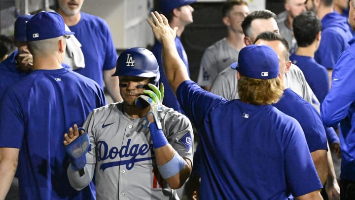 Los Angeles Dodgers shortstop Miguel Rojas (11), left, celebrates in the dugout after he scores against the Chicago White Sox during the seventh inning at Guaranteed Rate Field on June 24.