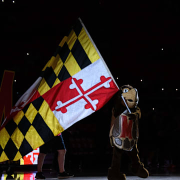 Dec 28, 2024; College Park, Maryland, USA; Maryland Terrapins mascot waves a flag before the game between the Maryland Terrapins and the Maryland-Eastern Shore Hawks  at Xfinity Center. Mandatory Credit: Reggie Hildred-Imagn Images