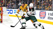 Minnesota Wild center Joel Eriksson Ek keeps the puck away from Vegas Golden Knights defenseman Noah Hanifin.