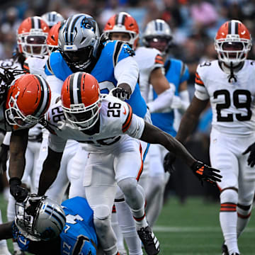 Aug 8, 2025; Charlotte, North Carolina, USA; Cleveland Browns safety Rayshawn Jenkins (28) rips off Carolina Panthers wide receiver Xavier Legette (17) helmet in the first quarter at Bank of America Stadium. Both players were ejected on the play. Mandatory Credit: Bob Donnan-Imagn Images